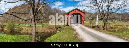 Graysville, Ohio, USA- Oct. 25, 2022: Web banner of Foraker Covered Bridge spanning the Little Muskingum River on a beautiful autumn day in rural Monr Stock Photo