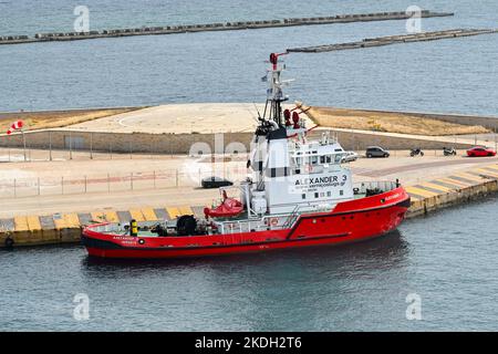 Piraeus, Athens, Greece - June 2022: Tug boat with firefighting water cannons moored in the port of Piraeus. Stock Photo