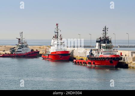 Piraeus, Athens, Greece - June 2022: Tug boats with firefighting water cannons moored in the port of Piraeus. Stock Photo