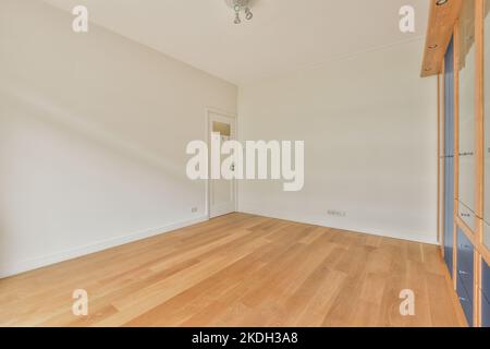 Interior of empty white room with large balcony windows with cupboard and parquet floor Stock Photo