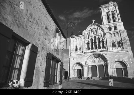 Cat welcoming visitors of famous  Vezelay abbey church in medieval village of Vezelay, Burgundy, France. Black white historic photo. Stock Photo