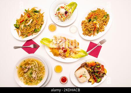 Set of Peruvian food dishes with a corvina ceviche in the center, soup with noodles, noodles sautéed with vegetables, causa limeña and lomo saltado Stock Photo