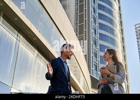 Businessmen working outdoors in front of office building Stock Photo