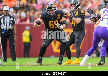 Washington Commanders cornerback Benjamin St-Juste (25) intercepts a pass  intended for Minnesota Vikings wide receiver Justin Jefferson (18) during  the second half of a NFL football game between the Washington Commanders and