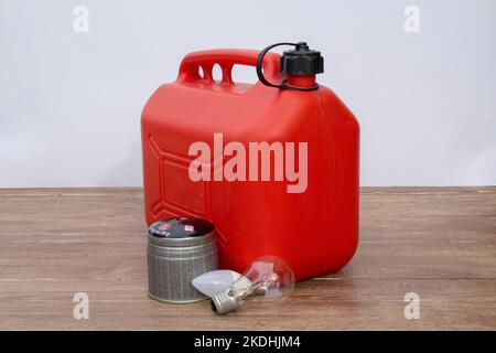 Image of a red petrol can, light bulbs and a can of gas. Reference to the increase in the price of these materials. Expensive of fuel, electricity Stock Photo