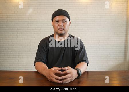 Asian youth wearing beanie and a black t-shirt. Stock Photo