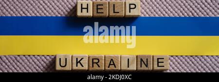 Help Ukraine text and Ukrainian flag closeup Stock Photo