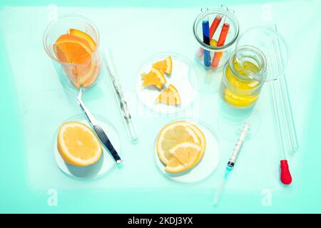 Laboratory glassware with plants and citrus fruits. top view Stock Photo