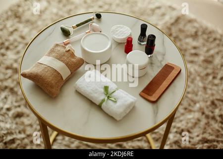 Top view background image of beauty supplies laid on round marble table in cozy setting, copy space Stock Photo
