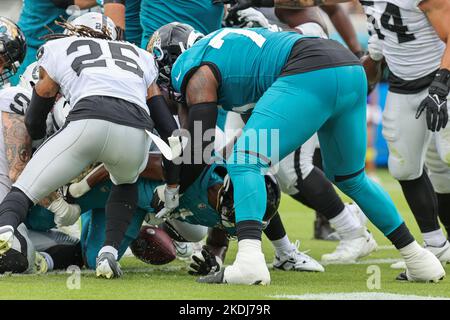 Saturday, November 6, 2022; Jacksonville, FL USA;  Jacksonville Jaguars running back Travis Etienne Jr. (1) punches through for the touchdown during a Stock Photo