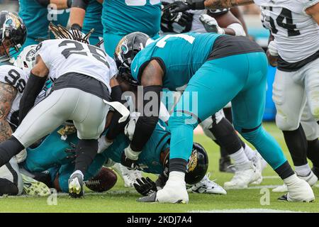 Saturday, November 6, 2022; Jacksonville, FL USA;  Jacksonville Jaguars running back Travis Etienne Jr. (1) punches through for the touchdown during a Stock Photo