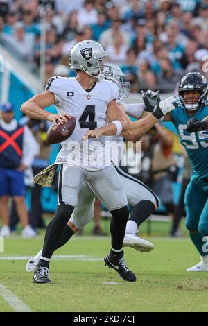 Saturday, November 6, 2022; Jacksonville, FL USA;  Las Vegas Raiders quarterback Derek Carr (4) drops back to pass during an NFL game against the Jack Stock Photo