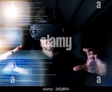 Decoding virtual reality. a young computer programmer wearing a vr headset while working on his code. Stock Photo