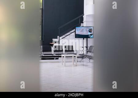 interior of empty hospital lobby with big windows waiting for patients. Modern healthcare facility, professional treatment room. Waiting area of emergency hospital reception Stock Photo