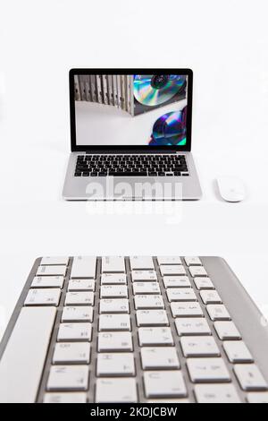 Laptop and keyboard isolated on white background. communication network. silver metal surface. digital modern communication computer technology Stock Photo