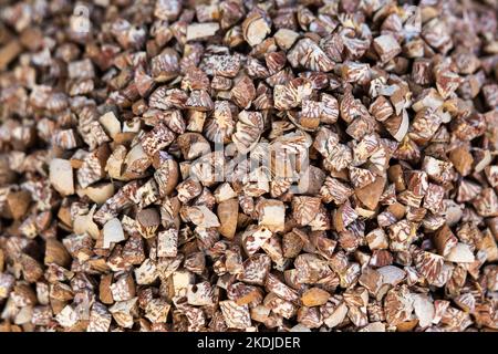 The cut Betel nut or Areca catechu was dry by the sunshine for eating. Stock Photo