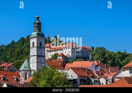 Town of Skofja Loka in Slovenia, townscape with castle St. Jacob Church tower, Upper Carniola region. Stock Photo