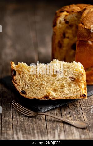 Panettone Christmas Cake. Italian sweet bread on the wooden table. Stock Photo