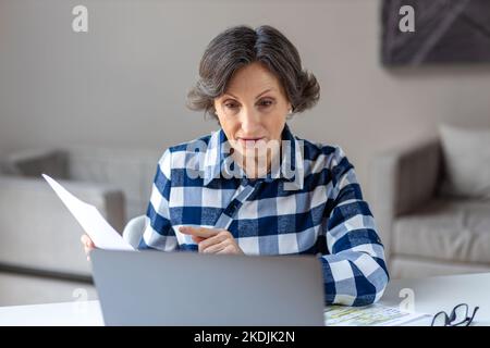 Businesswoman having video meeting with employees or partners using laptop for remote work Stock Photo
