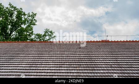 Shingled roof with a lightning protection system on the ridge. Polish traditional house Stock Photo