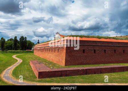 Zamość Fortress. The perfect city. City walls. The storm clouds are closing in on the city. Baroque church in the background. The city is inscribed on Stock Photo