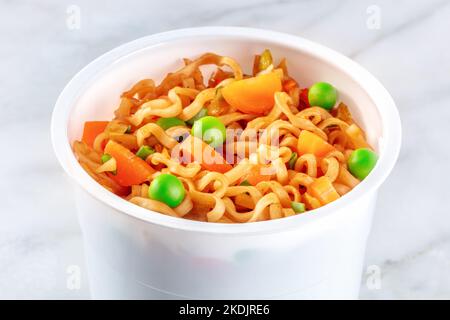 Ramen cup, instant soba noodles in a plastic cup with vegetables, a close-up Stock Photo
