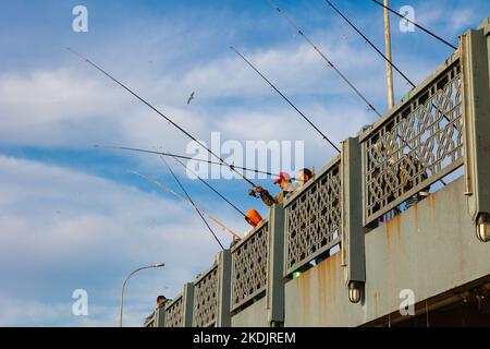 Fishermen on the Galata Bridge. Citizens or city life of Istanbul. Istanbul Turkey - 5.7.2022 Stock Photo