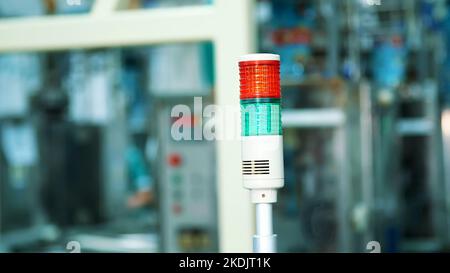 production, workshop, close-up of a special lamp of red and green color. there is a manufacturing process, a work process. High quality photo Stock Photo