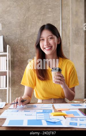 UX Developer and ui designer brainstorming about app interface design at modern office. Creative digital development agency Stock Photo
