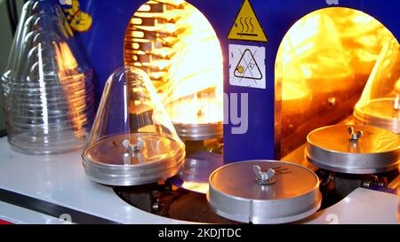 production, the process of preparation of plastic blanks, the heating of blanks in a special machine, apparatus. High quality photo Stock Photo