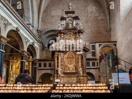 Great view of the side-altar with lighted votive candles in the famous High Cathedral of Saint Peter in Trier or Trier Cathedral, a Roman Catholic... Stock Photo
