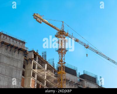 Crane used for skyscraper construction at construction site on a sunny clean day Stock Photo
