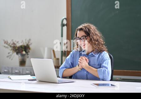 Young happy business woman feeling excited looking at laptop reading good news. Stock Photo