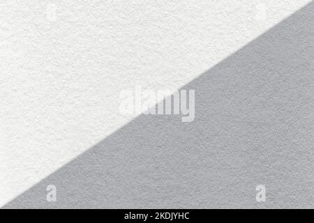 Texture of craft white and gray paper background, half two colors, macro. Structure of vintage dense kraft grey cardboard. Felt abstract backdrop clos Stock Photo