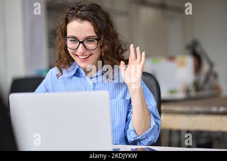 Happy business woman using laptop for remote virtual work conference meeting. Stock Photo