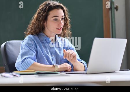 Young woman, female teacher teaching online remote class working in office. Stock Photo