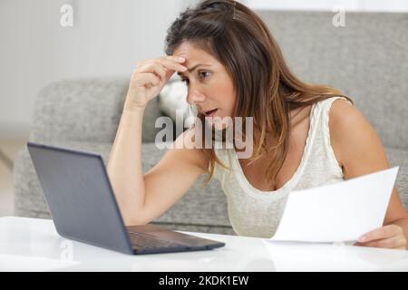 worried woman reading bad news in letter Stock Photo