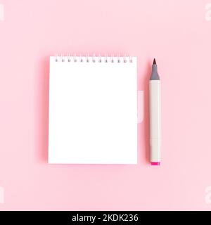 Clean notepad mockup and felt tip pen on a pink pastel background. Empty notebook template. Stock Photo