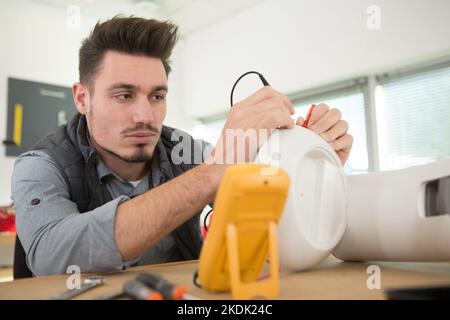 man is fixing the coffee machine Stock Photo