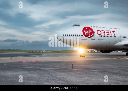 Virgin logo on the fuselage of the Virgin Orbit, Cosmic Girl, a 747-400 converted to a rocket launch platform taxiing at Spaceport Cornwall Stock Photo