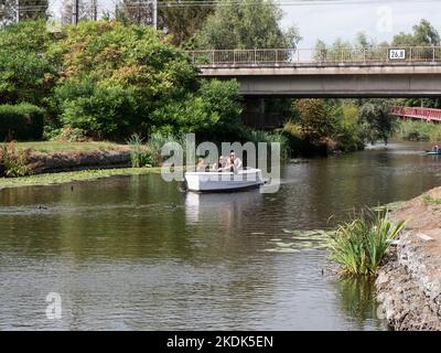Lokeren, Belgium, August 27, 2022, A family with their children enjoy a boat trip on the river Durme Stock Photo
