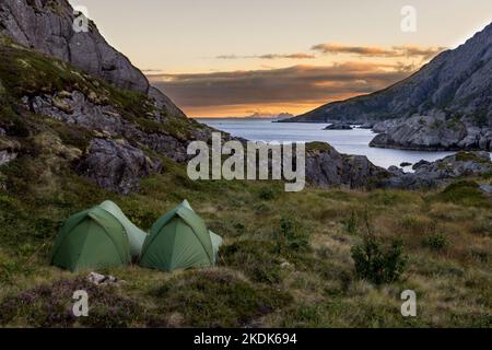 two green Tents at beautiful Landscape on Lofoten Islands  nusfjord in scandinavia, europe, hiking backpacking Stock Photo