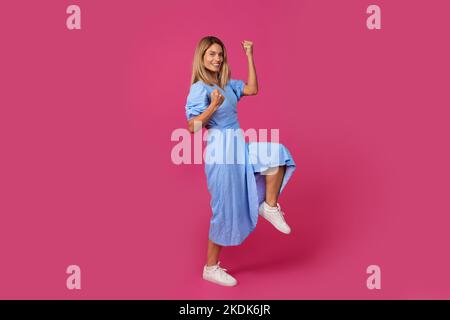 Happy excited adult european woman doing success gesture and celebrating victory Stock Photo