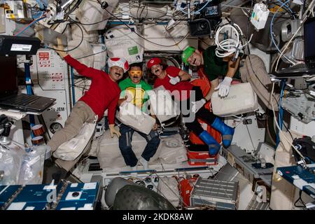 ISS - 31 October 2022 - Four ISS Expedition 68 Flight Engineers dress up as popular video game and cartoon characters to celebrate Halloween fun aboar Stock Photo