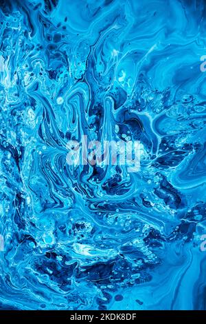 Free flowing blue and white acrylic paint. Random Waves and Curls. Abstract marble background or texture. Stock Photo