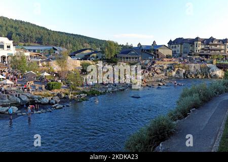 The San Juan River flows through Pagosa Springs, Colorado at dusk with its hot springs and Springs Resort on one side and the riverwalk on the other. Stock Photo