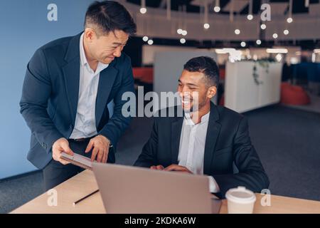 Two smiling coworkers working together on project in modern office  Stock Photo