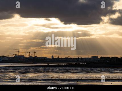 Sun rays beaming down on Clontarf during sunset Stock Photo