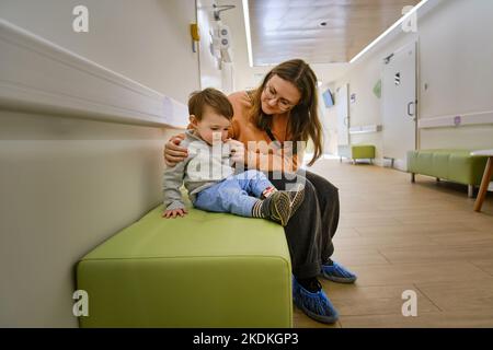 Mother and son with doctor at hospital reception Stock Photo - Alamy