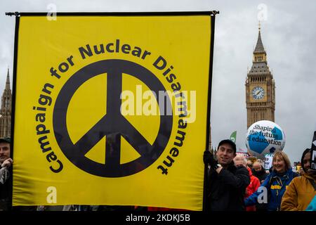Supporters with a banner "Campaign for Nuclear Disarmament "(CND) during a demonstration against the Conservative government. Stock Photo